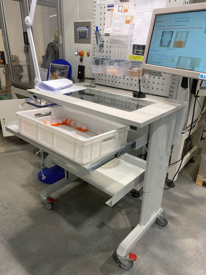 An electric Concept bench with a special glass plate and pull-out shelf to keep items off the tabletop and so that the operator can check  the condition of the sampling parts.
